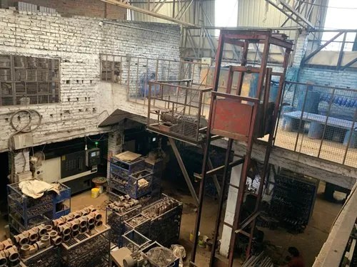 Valve castings stacked in crates on the factory floor